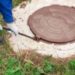 The,Worker,Opens,The,Manhole,Cover,To,Inspect,And,Check