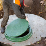 A,Worker,Installs,A,Sewer,Manhole,On,A,Septic,Tank