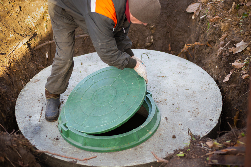 A,Worker,Installs,A,Sewer,Manhole,On,A,Septic,Tank